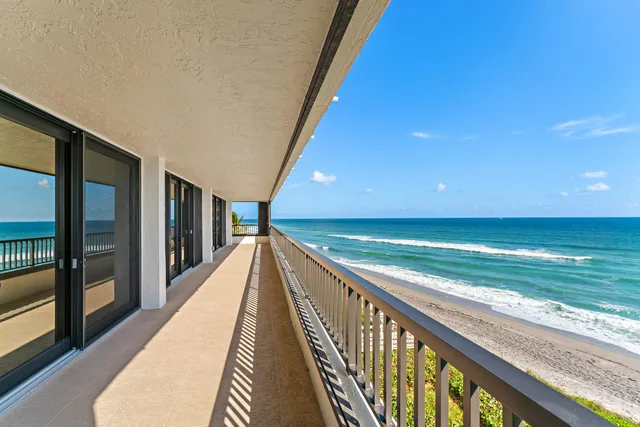 a kitchen with a sink a stove cabinets dining table and chairs