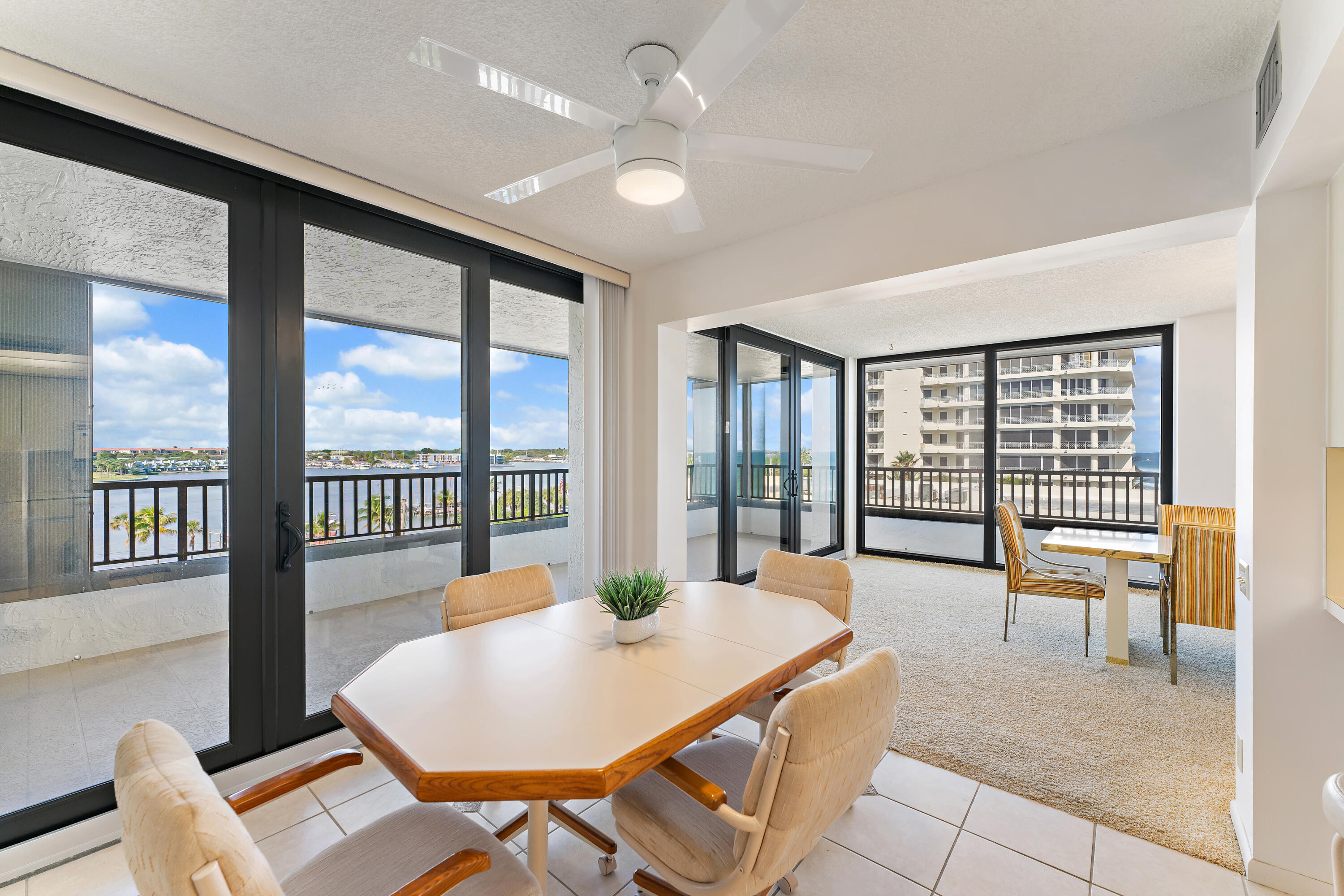 19900 South Beach Road, Unit 601 Jupiter, FL 33469 - Photo 27 of 84 a dining room with furniture a chandelier and wooden floor