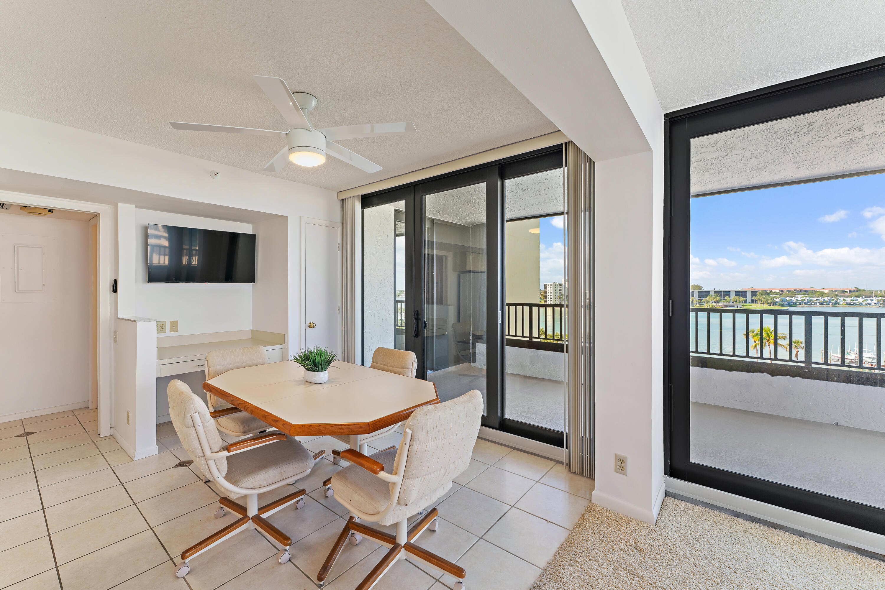 19900 South Beach Road, Unit 601 Jupiter, FL 33469 - Photo 28 of 84 a living room with a table and chairs