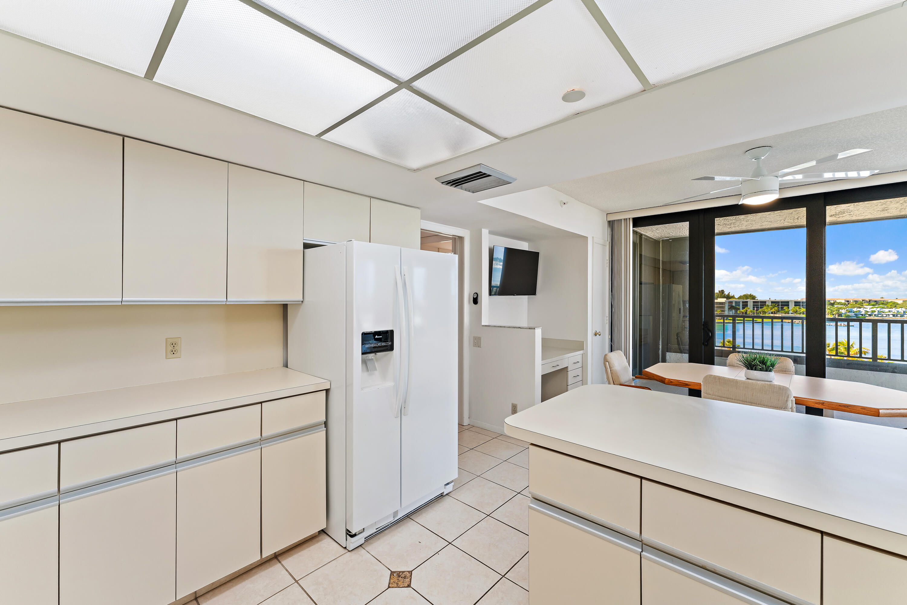 19900 South Beach Road, Unit 601 Jupiter, FL 33469 - Photo 33 of 84 a kitchen with stainless steel appliances a refrigerator sink and cabinets