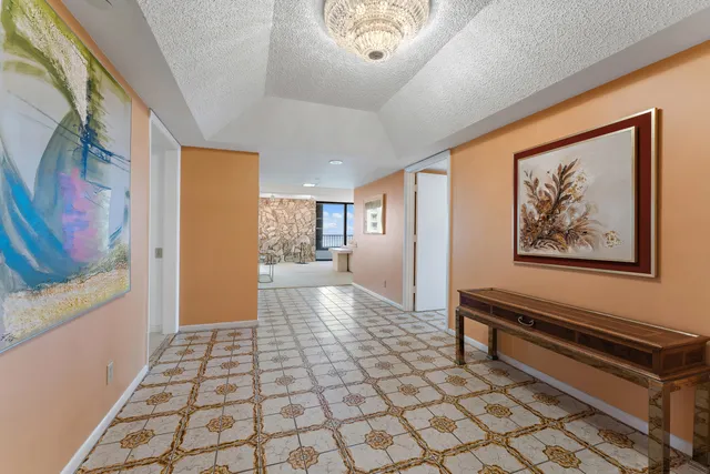 a bedroom with bed and a chandelier