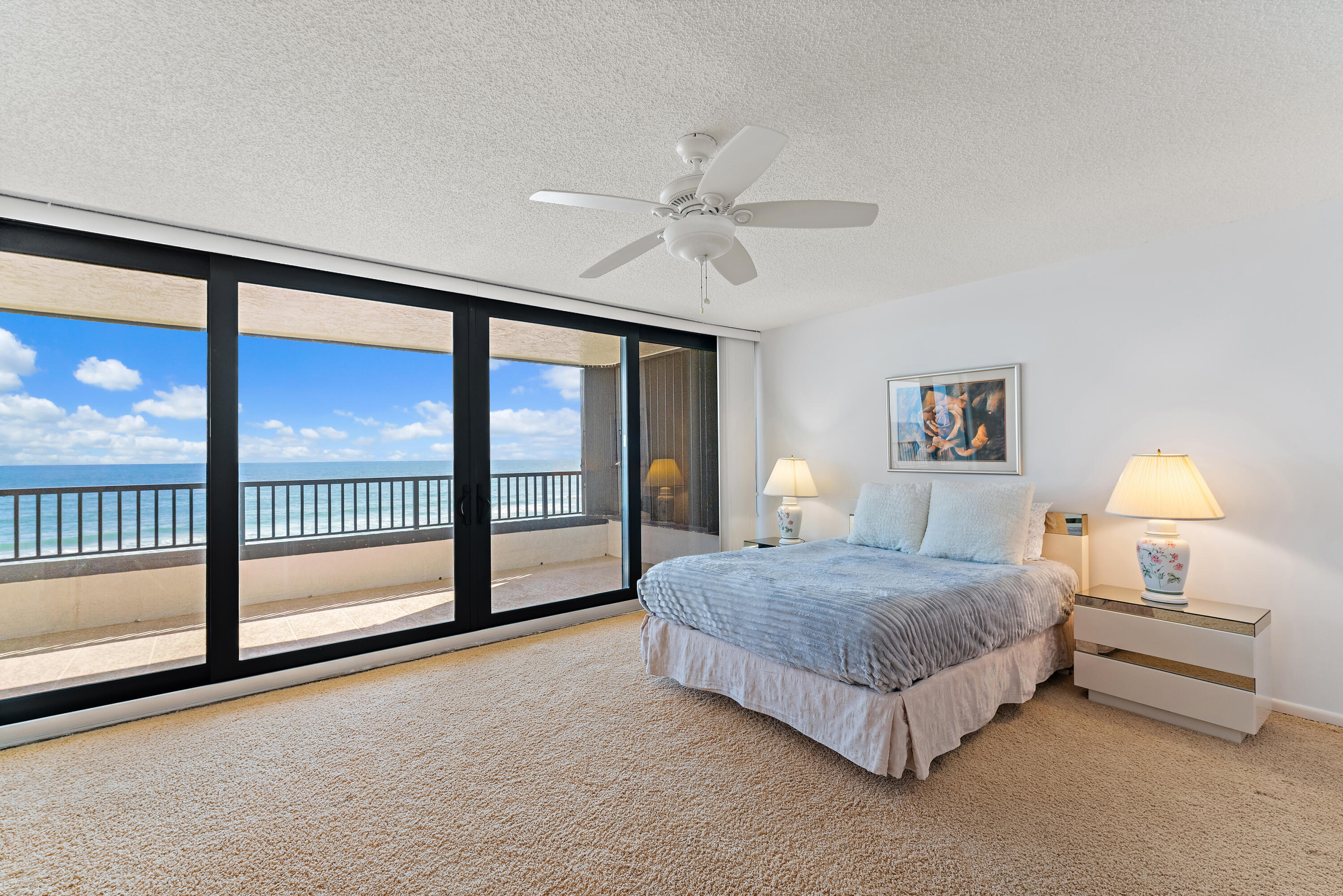 19900 South Beach Road, Unit 601 Jupiter, FL 33469 - Photo 44 of 84 a spacious bedroom with a bed and a large window