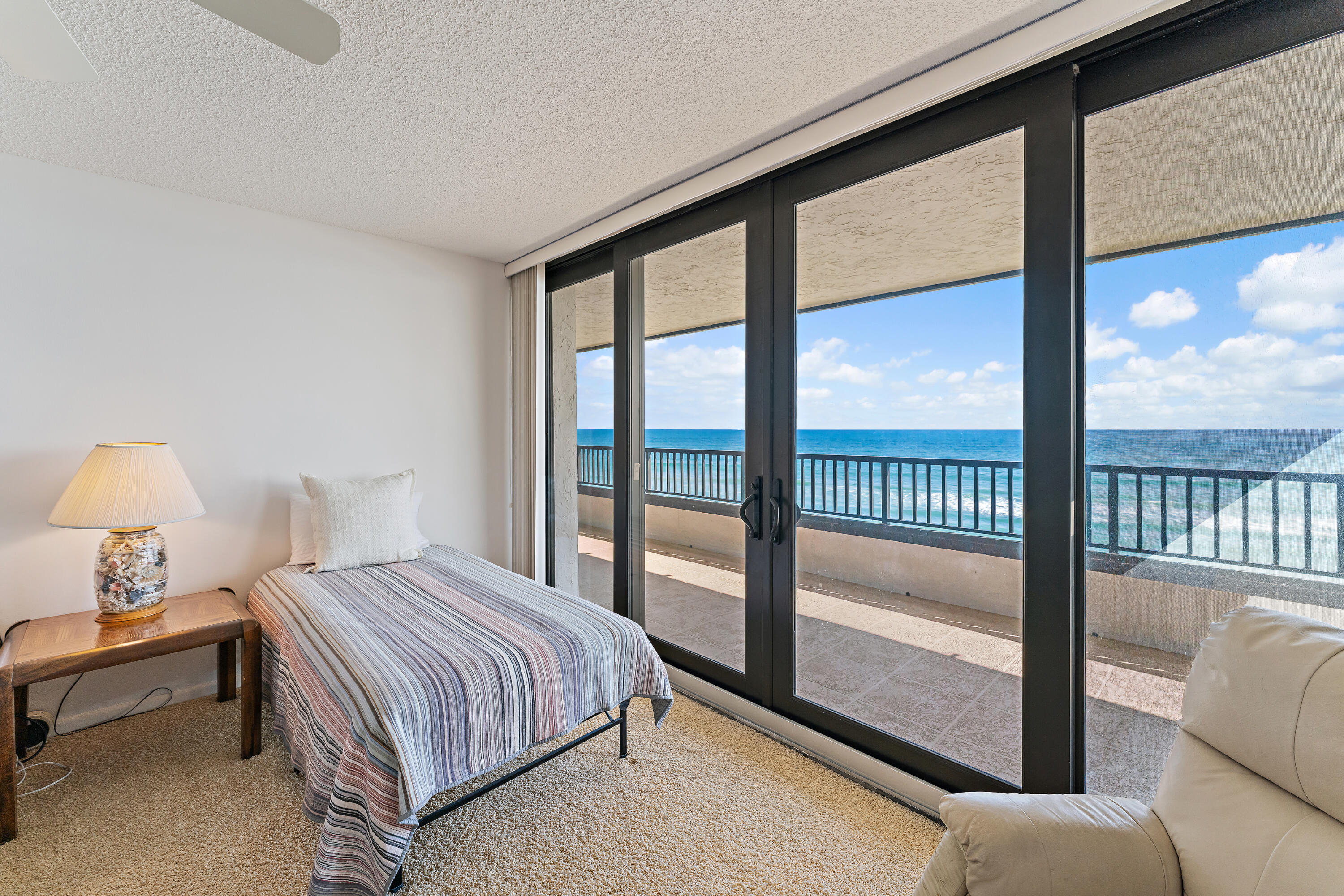 19900 South Beach Road, Unit 601 Jupiter, FL 33469 - Photo 56 of 84 a bedroom with a balcony a bed and a large window