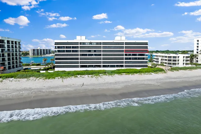 a living room with furniture and large windows