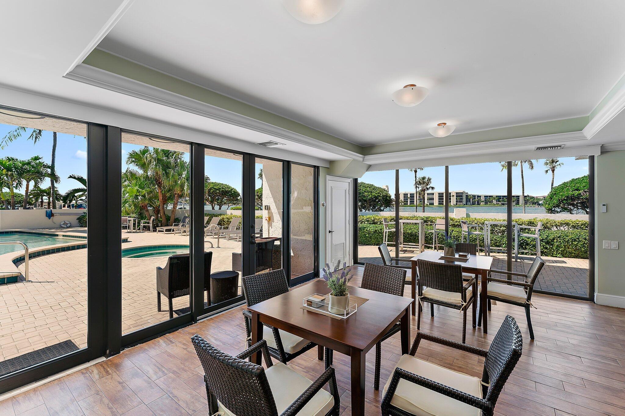 19900 South Beach Road, Unit 601 Jupiter, FL 33469 - Photo 77 of 84 a view of a city from a dining room with furniture and floor to ceiling windows