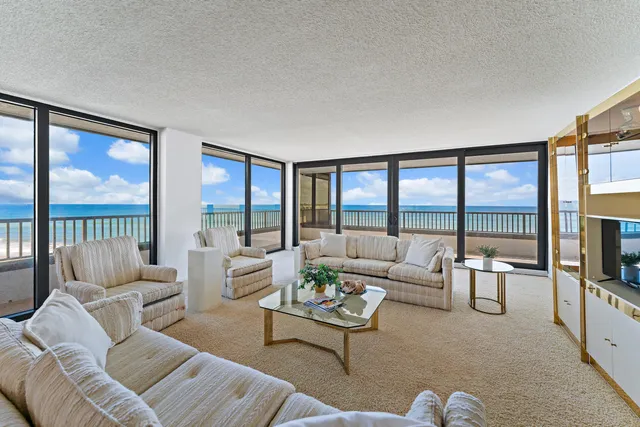 a living room with furniture large window and flat screen tv