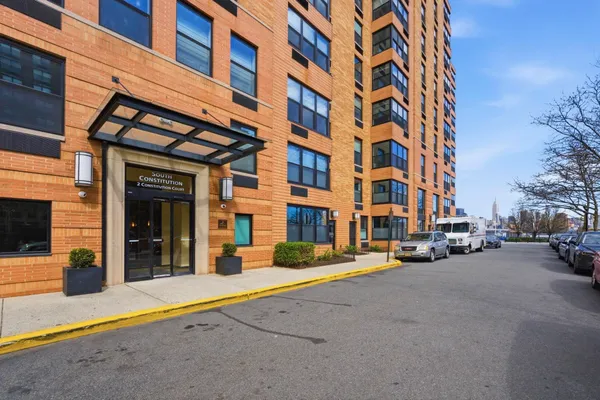 a building exterior with water fountain in front of it