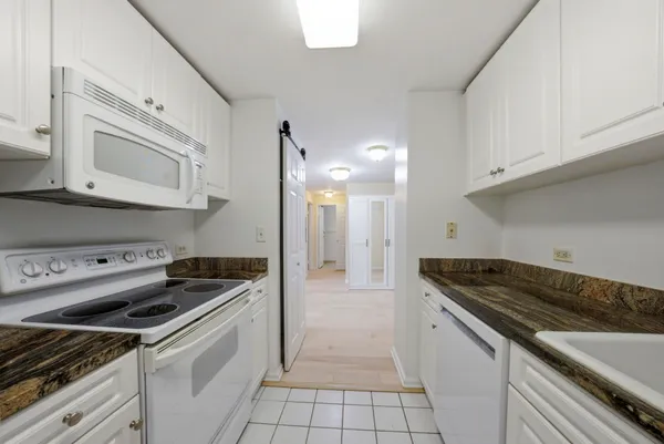 a kitchen with cabinets and steel appliances