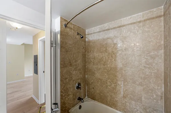 a bathroom with a shower and a sink