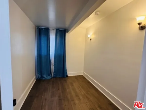 a view of hallway with wooden floor