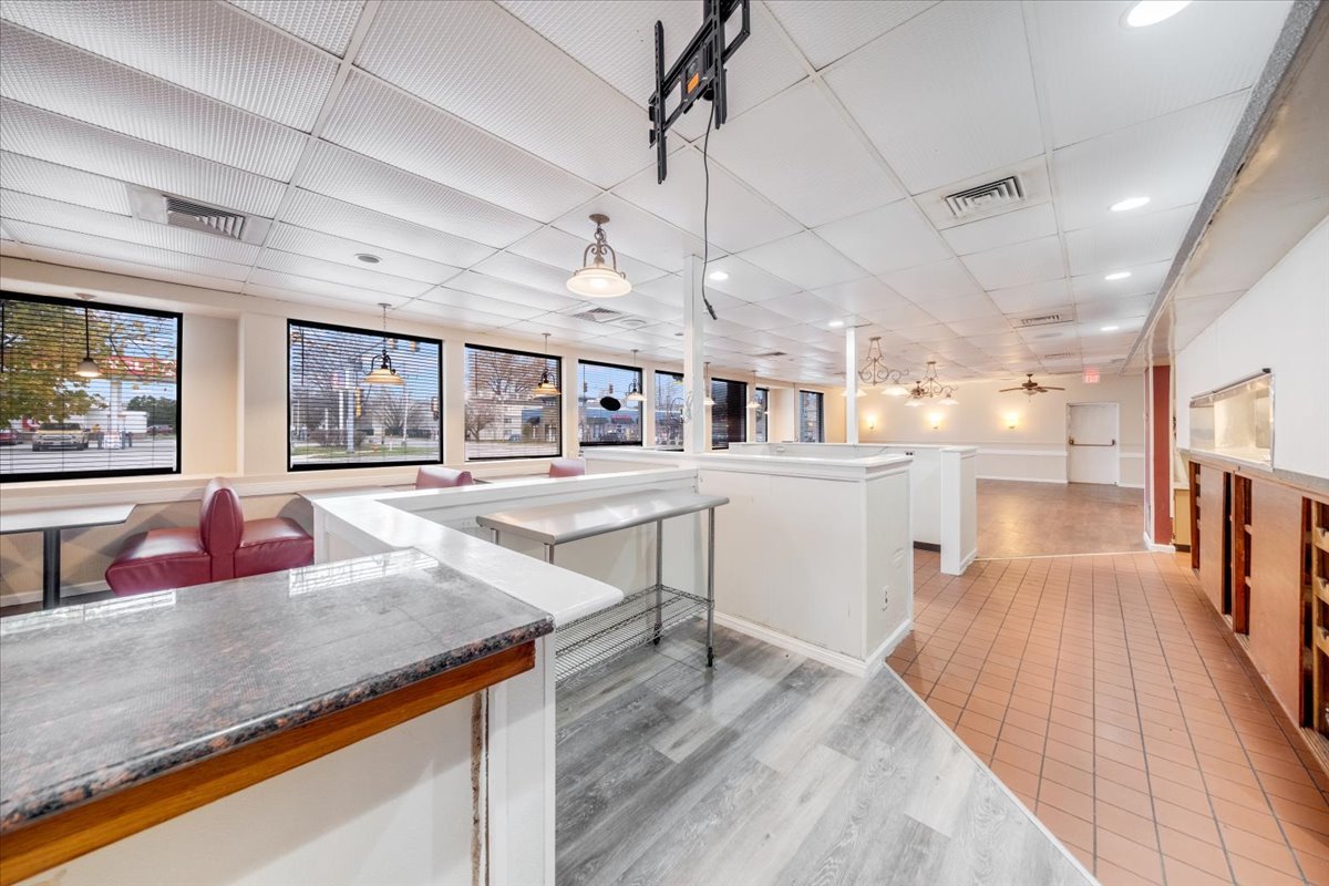 2312 West Springfield Avenue Champaign, IL 61821 - Photo 11 of 48 a living room with stainless steel appliances kitchen island granite countertop furniture and a kitchen view