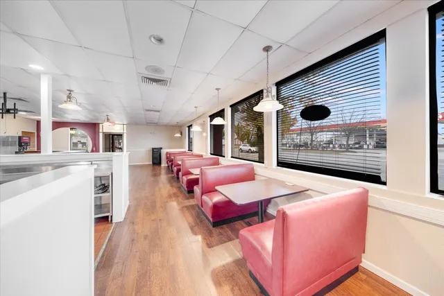 a view of a room with wooden floor