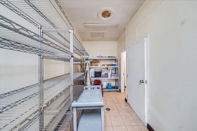 a room with stainless steel appliances kitchen island granite countertop furniture and a kitchen view