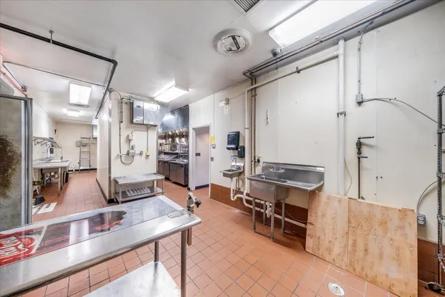 a room with table chairs and a stove