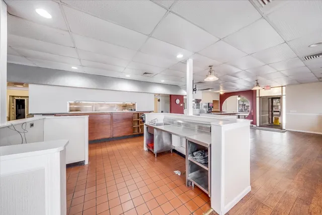 a open kitchen with cabinets a oven and a counter top space