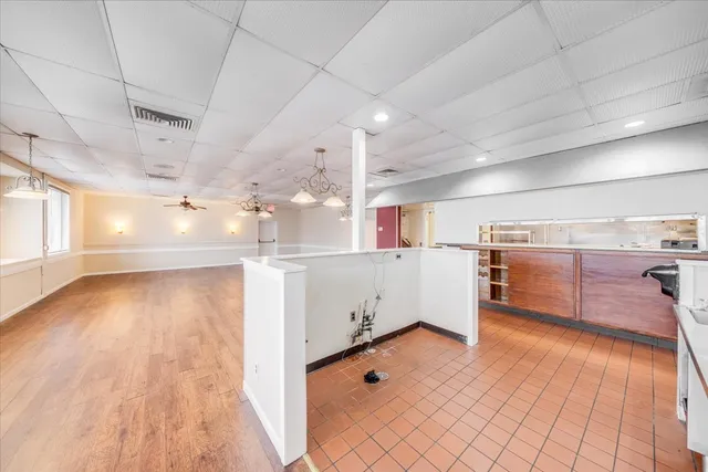 a kitchen with stainless steel appliances granite countertop a sink a stove and a wooden floors