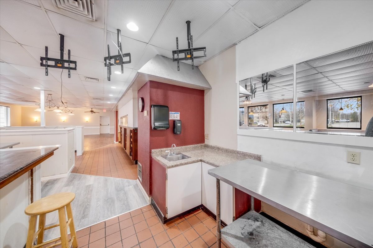 2312 West Springfield Avenue Champaign, IL 61821 - Photo 10 of 48 a kitchen with stainless steel appliances granite countertop a sink a stove and a wooden floors