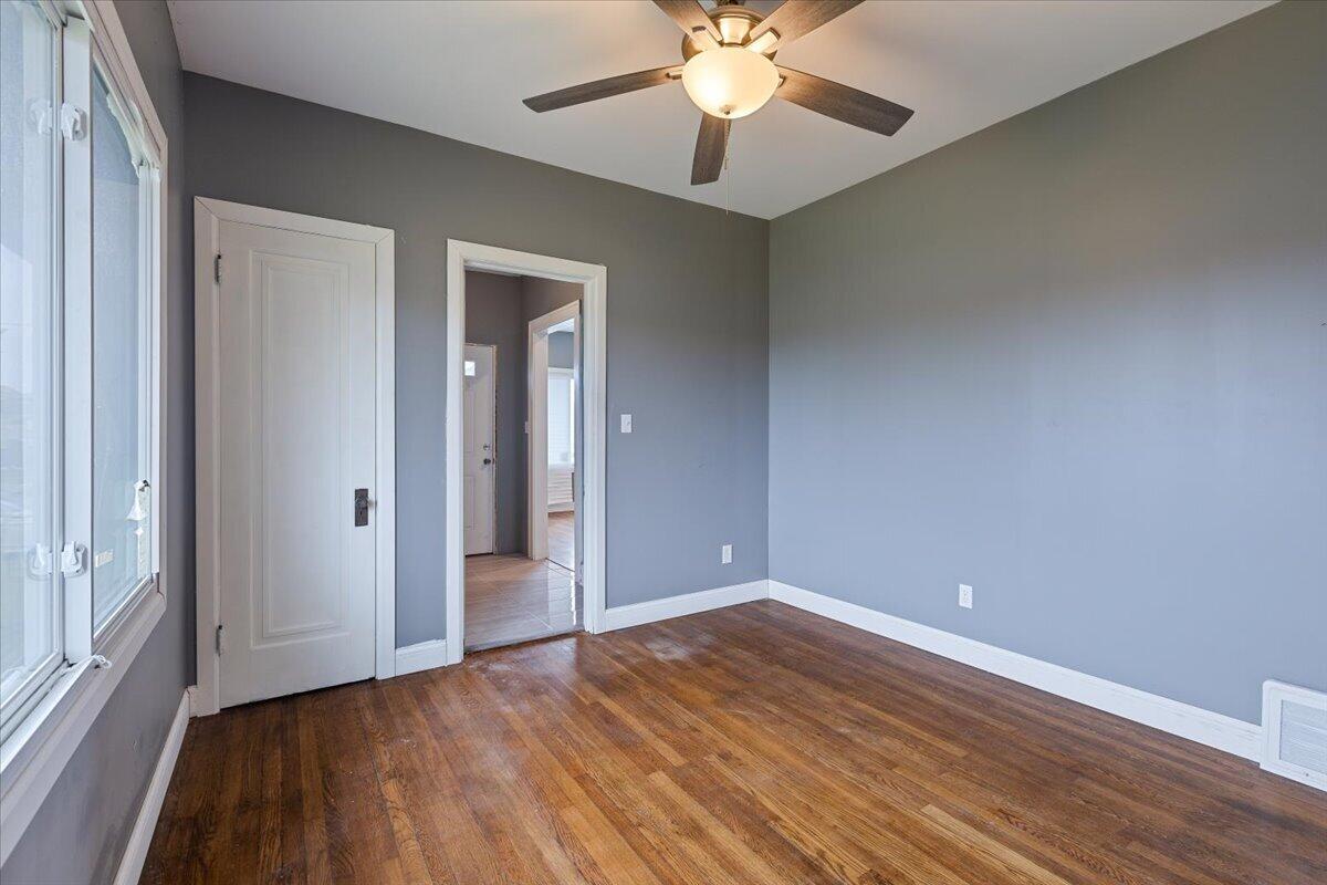 456 Bridge Street Gary, IN 46404 - Photo 13 of 27 an empty room with wooden floor and windows