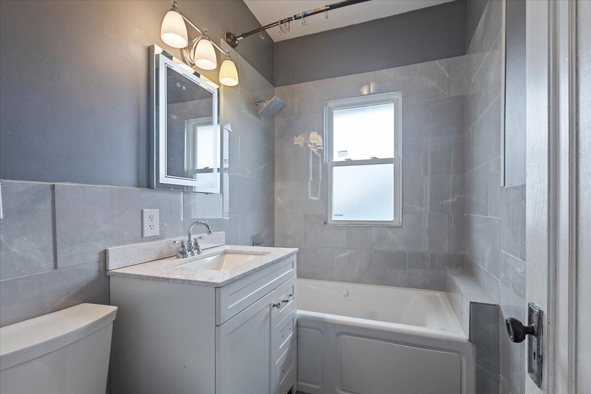 456 Bridge Street Gary, IN 46404 - Photo 15 of 27 a bathroom with a sink toilet vanity and tub