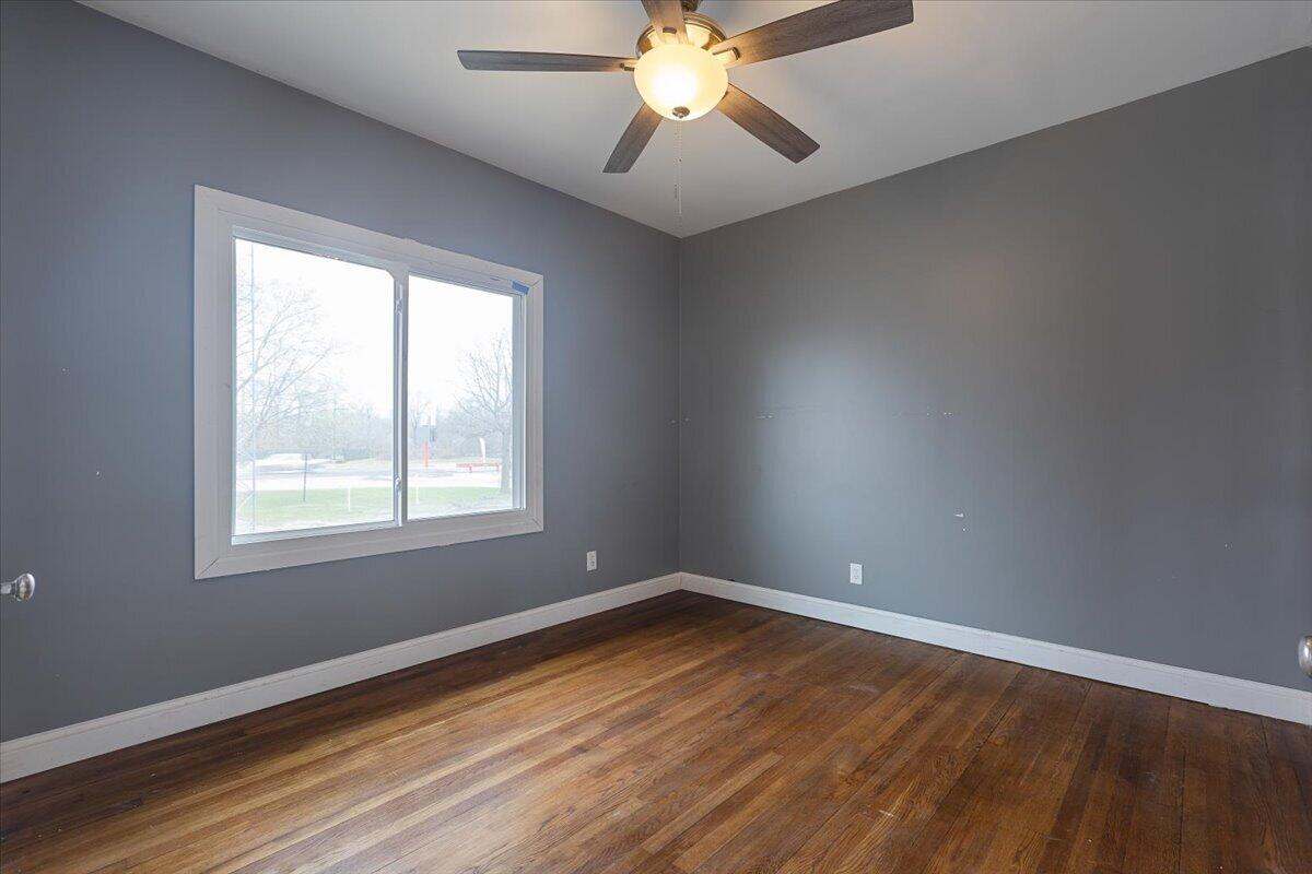 456 Bridge Street Gary, IN 46404 - Photo 16 of 27 an empty room with wooden floor and windows