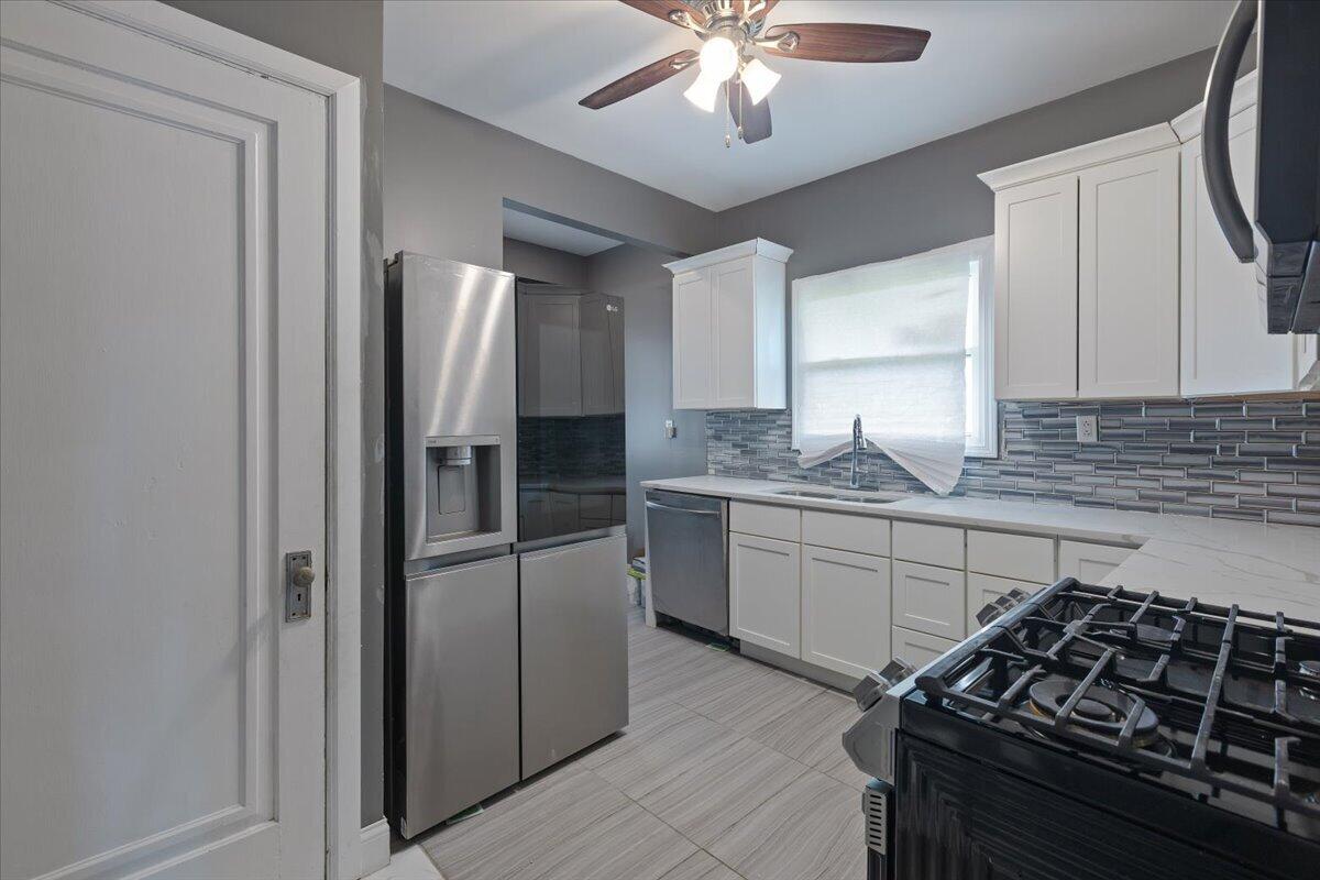 456 Bridge Street Gary, IN 46404 - Photo 18 of 27 a kitchen with a refrigerator and a stove top oven