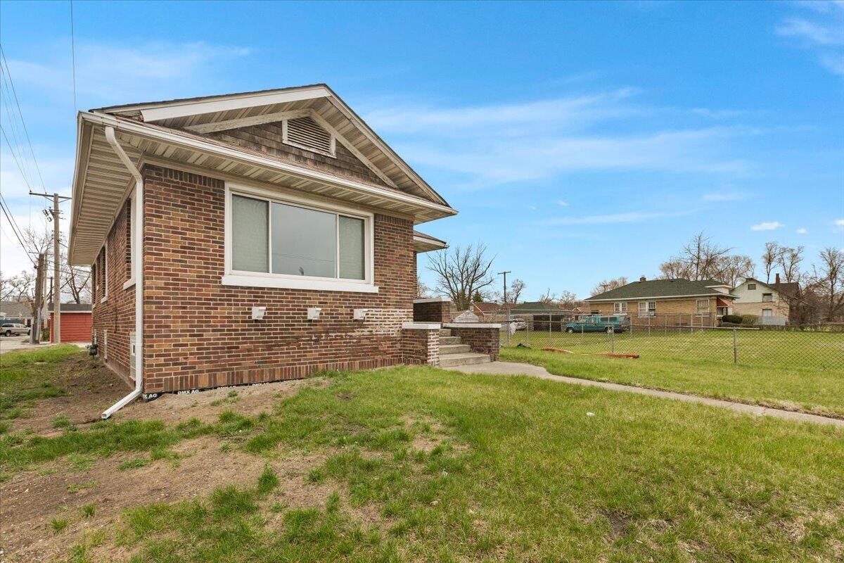 456 Bridge Street Gary, IN 46404 - Photo 2 of 27 a front view of a house with a yard