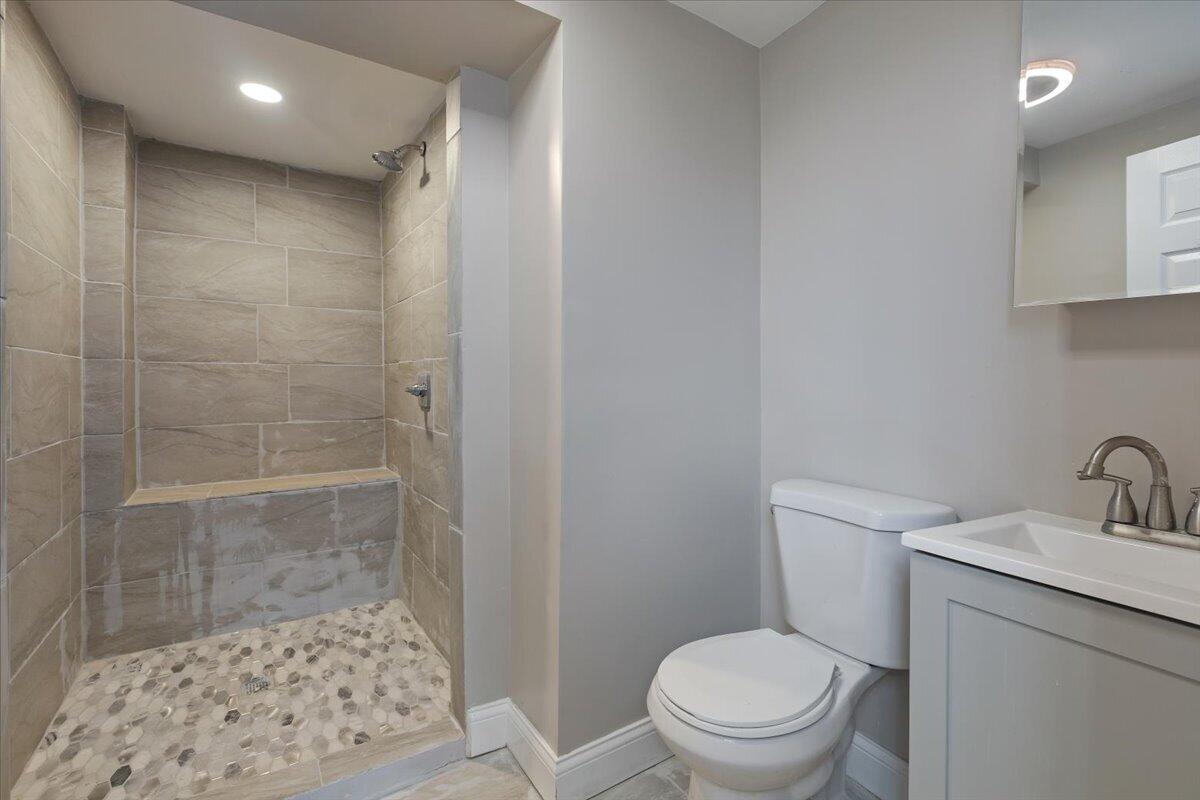 456 Bridge Street Gary, IN 46404 - Photo 21 of 27 a bathroom with a toilet a sink and a shower