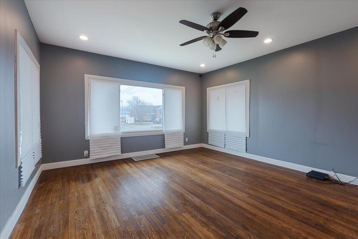 456 Bridge Street Gary, IN 46404 - Photo 7 of 27 an empty room with wooden floor and windows