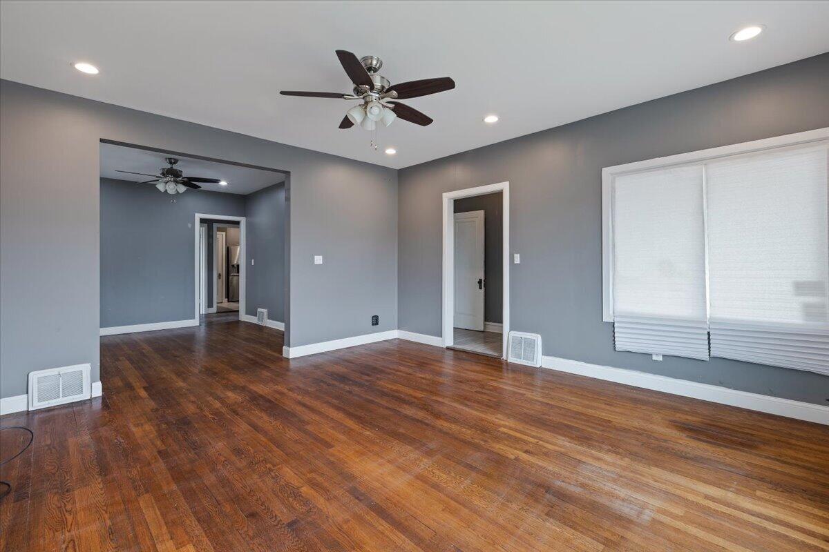 456 Bridge Street Gary, IN 46404 - Photo 8 of 27 a view of empty room with wooden floor and window