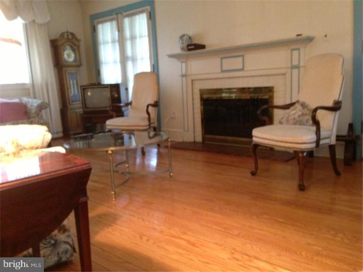 411 Vernon Road Jenkintown, PA 19046 - Photo 4 of 17 a living room with furniture a fireplace and a table