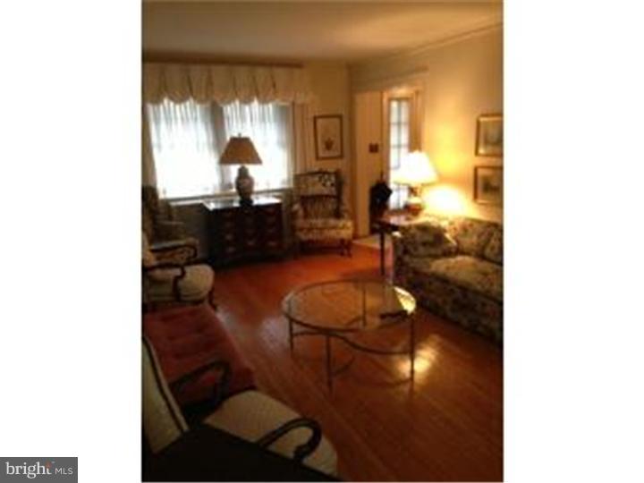 411 Vernon Road Jenkintown, PA 19046 - Photo 5 of 17 a living room with furniture and a chandelier