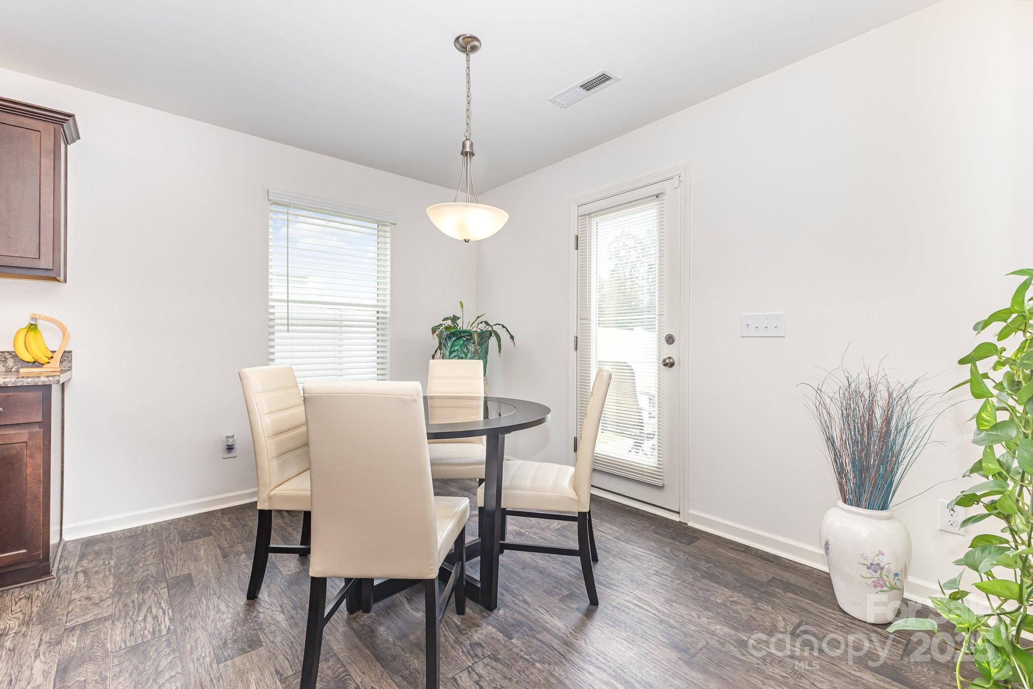 12926 Hill Pine Road Midland, NC 28107 - Photo 12 of 30 a view of a dining room with furniture and a potted plant