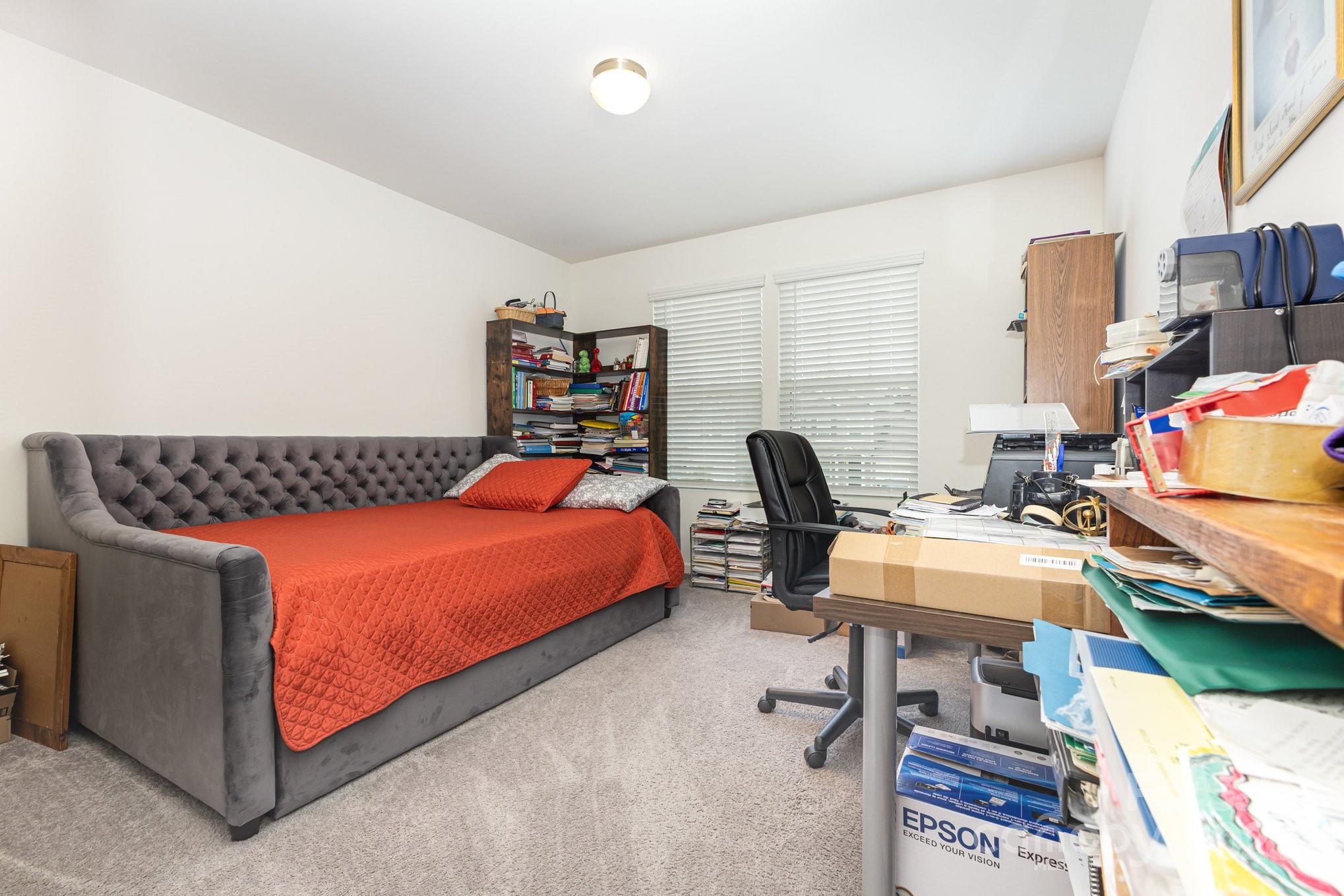 12926 Hill Pine Road Midland, NC 28107 - Photo 22 of 30 a bedroom with a bed and a book shelf