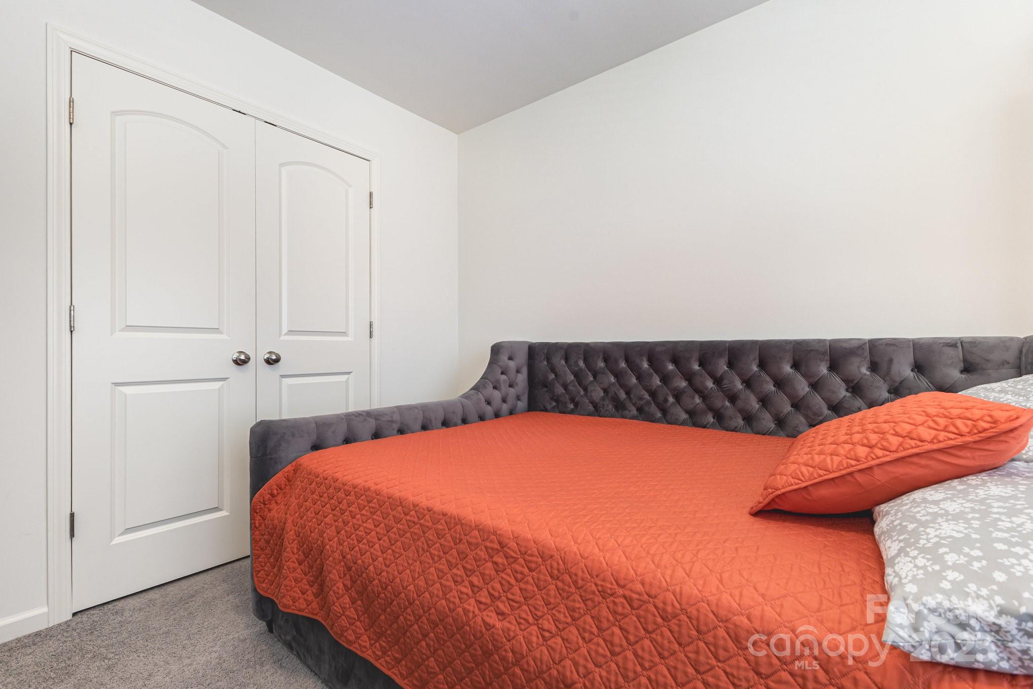 12926 Hill Pine Road Midland, NC 28107 - Photo 23 of 30 a bedroom with a bed and pillows