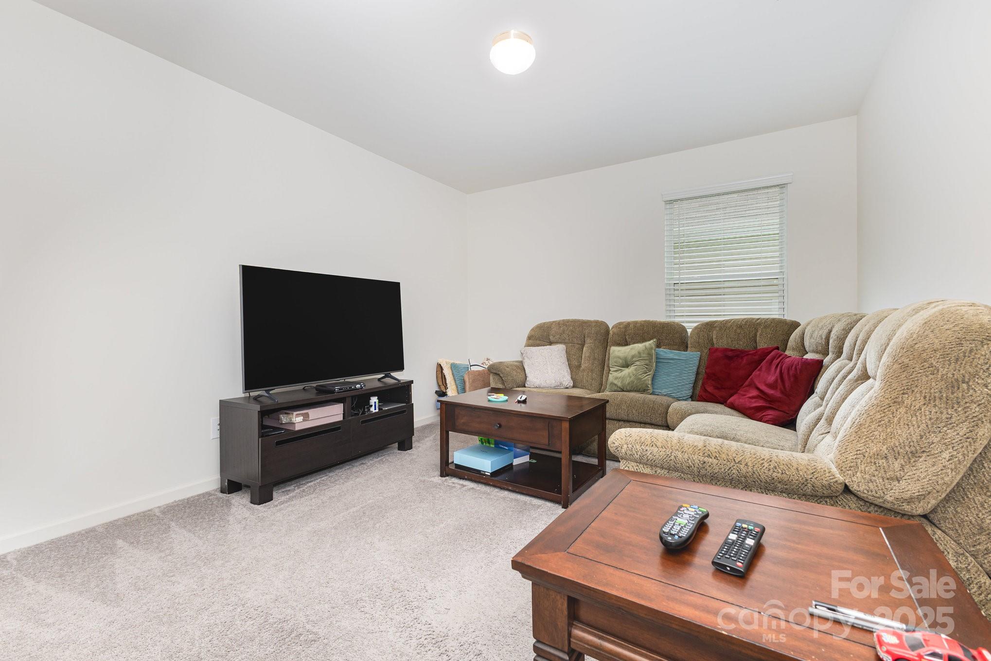 12926 Hill Pine Road Midland, NC 28107 - Photo 24 of 30 a living room with furniture and a flat screen tv