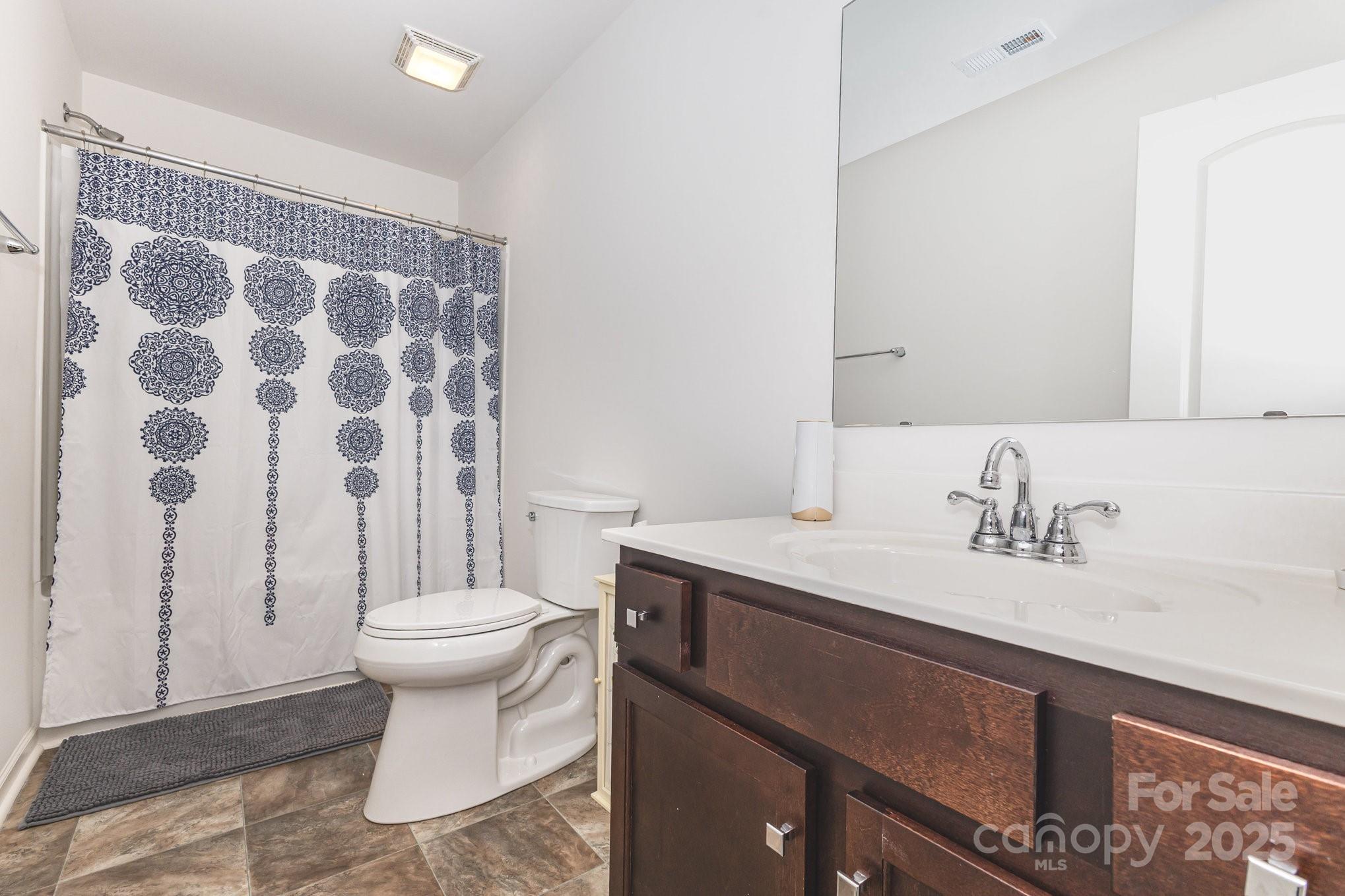 12926 Hill Pine Road Midland, NC 28107 - Photo 27 of 30 a bathroom with a sink toilet and shower