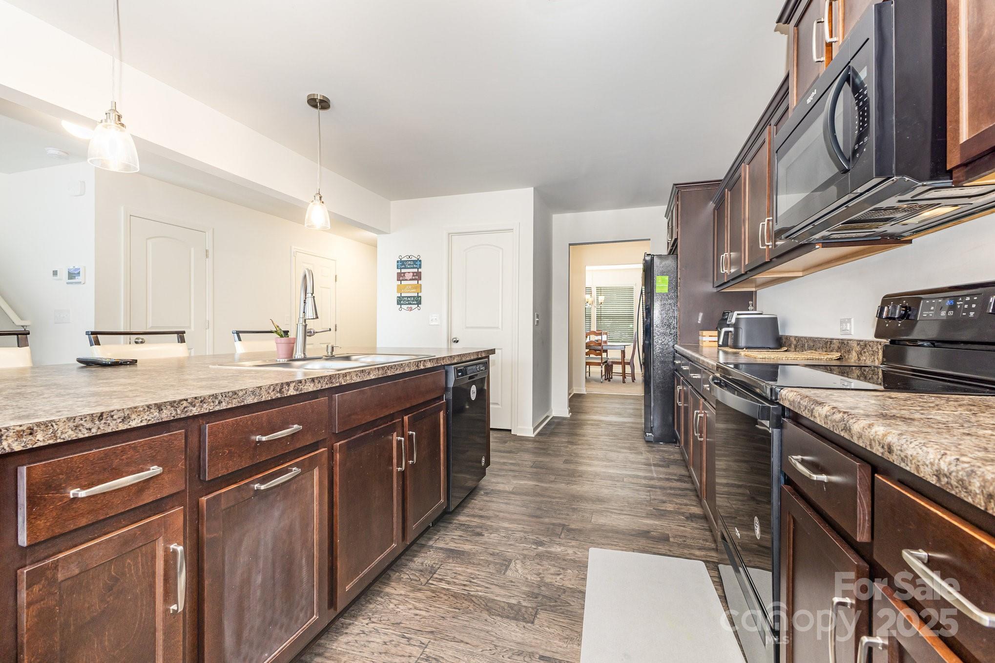 12926 Hill Pine Road Midland, NC 28107 - Photo 9 of 30 a large kitchen with stainless steel appliances granite countertop a lot of counter space and a sink