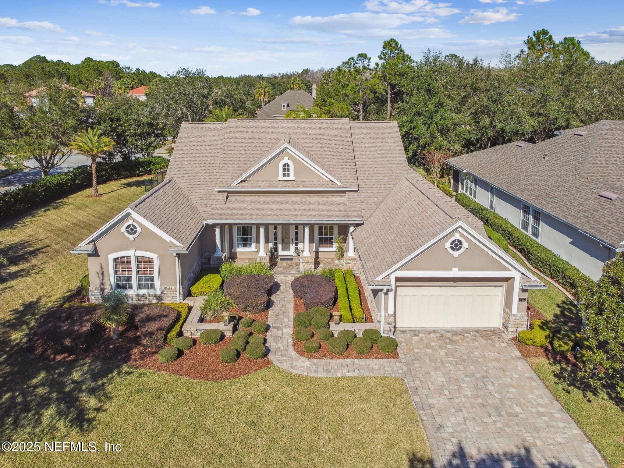 an aerial view of a house with swimming pool and a yard