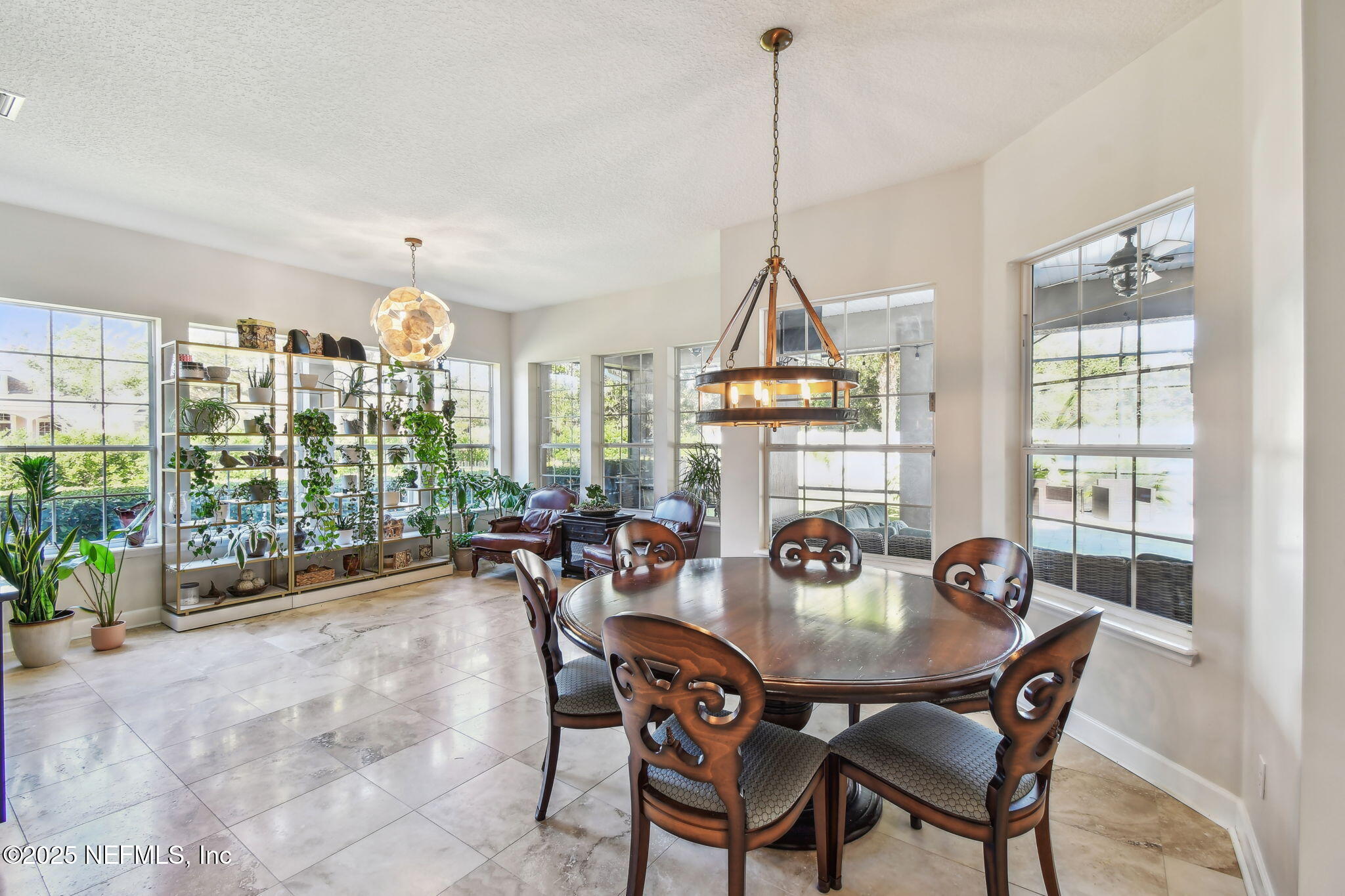 100 La Mesa Drive St. Augustine, FL 32095 - Photo 19 of 49 a dining room with furniture a chandelier and wooden floor