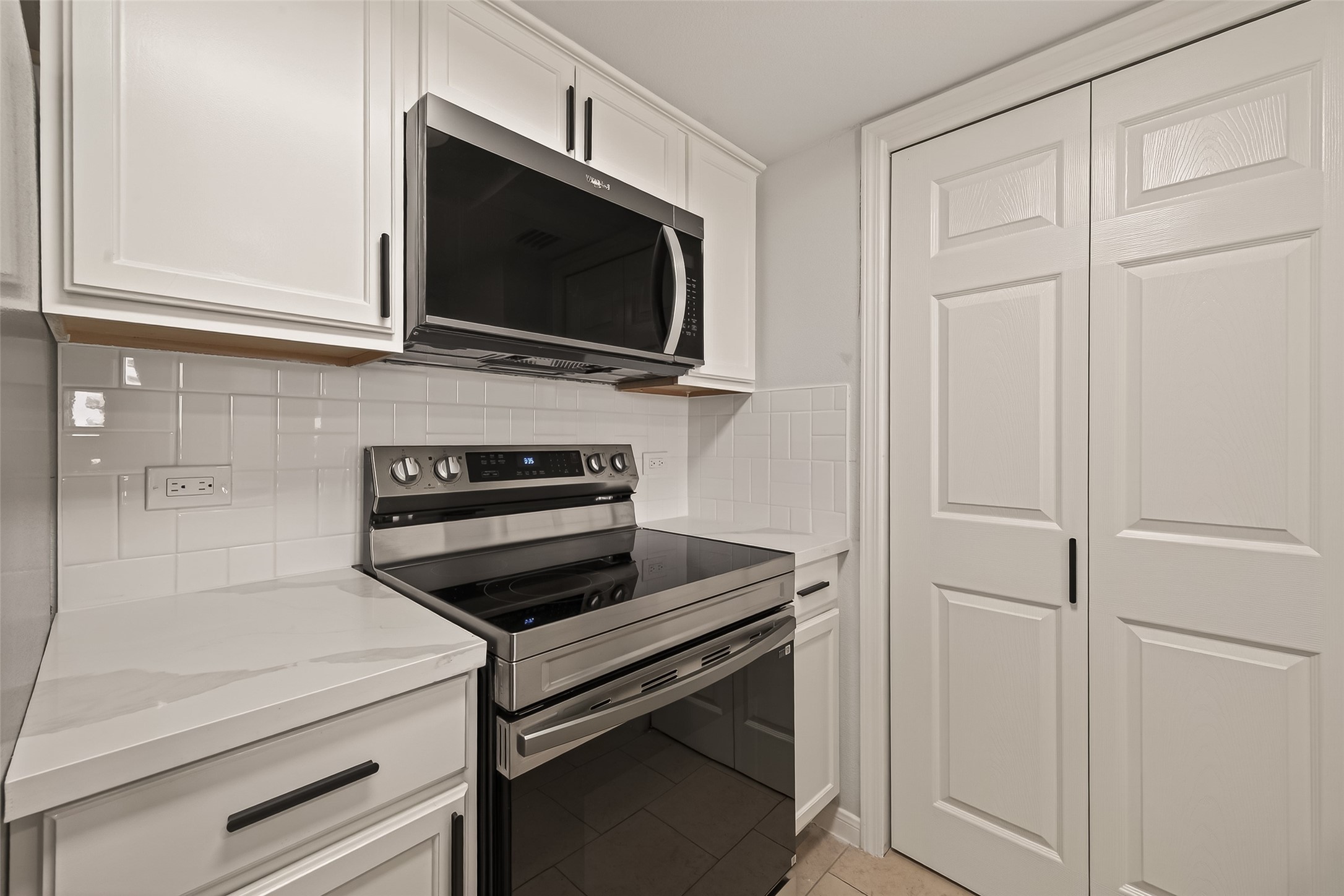 3525 Sage Road, Unit 1405 Houston, TX 77056 - Photo 16 of 37 a kitchen with a microwave and cabinets