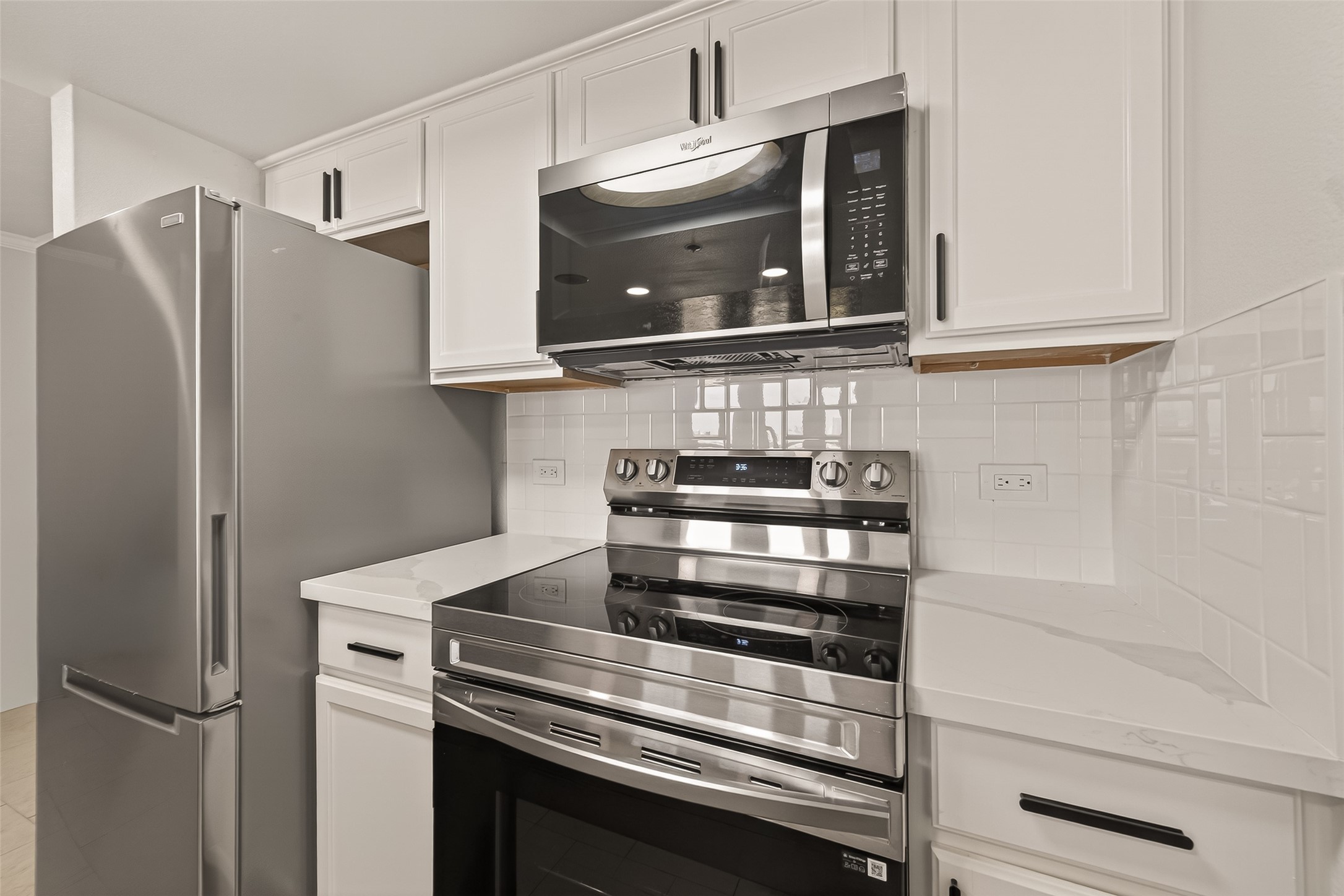 3525 Sage Road, Unit 1405 Houston, TX 77056 - Photo 18 of 37 a kitchen with stainless steel appliances white cabinets and a refrigerator
