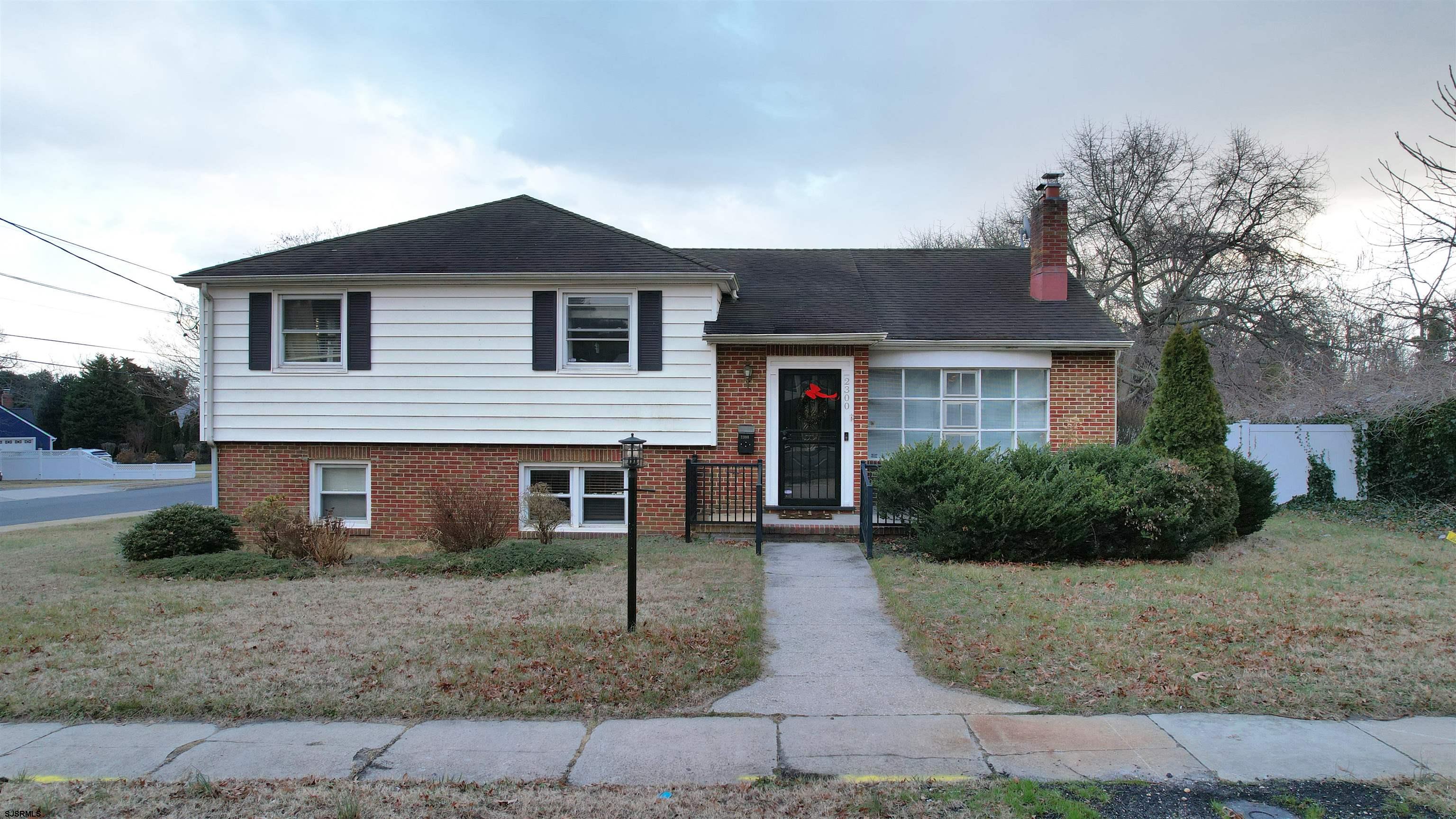 2300 Shore Road Linwood, NJ 08221 - Photo 24 of 50 a front view of a house with a yard and garage