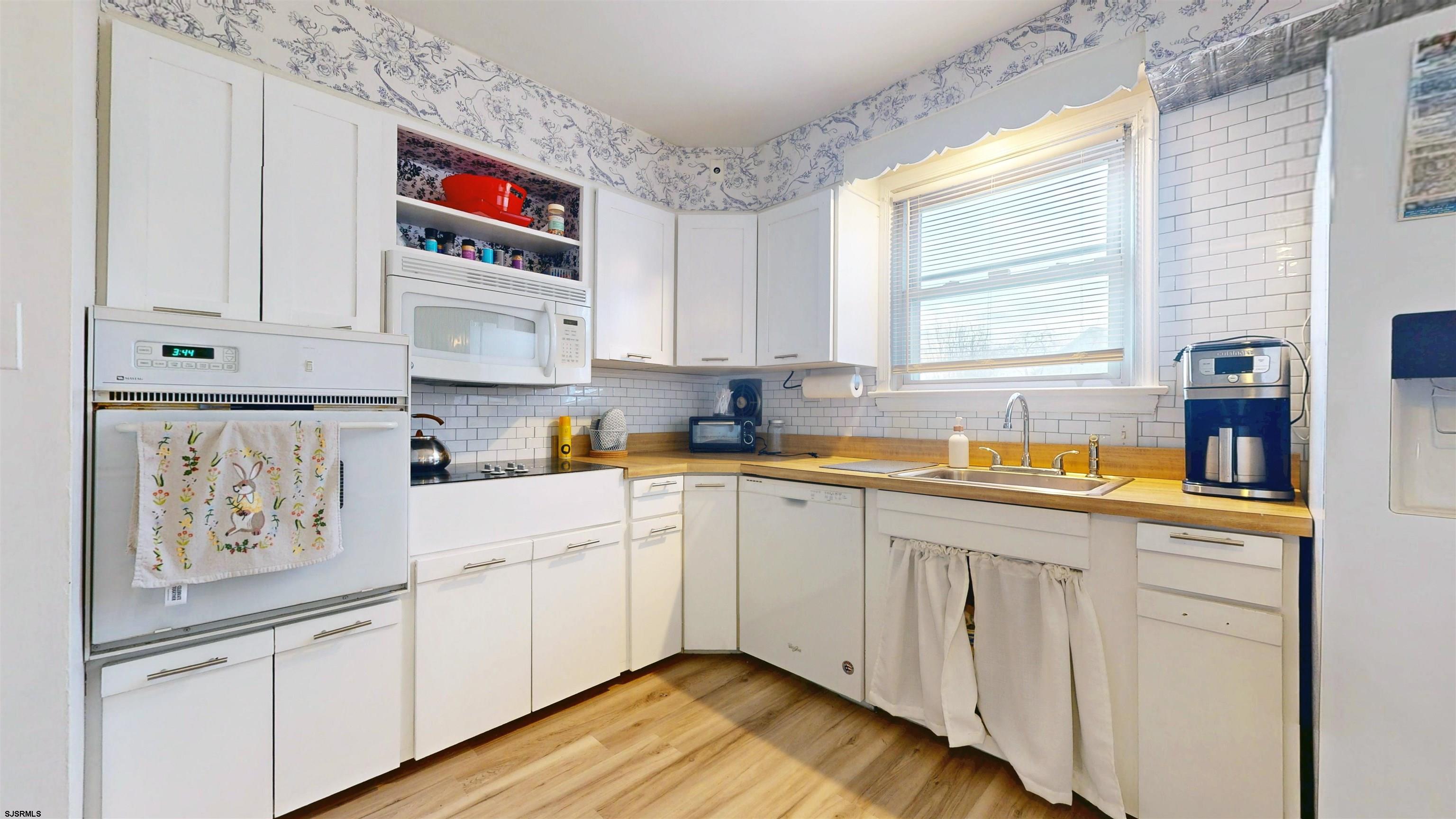 2300 Shore Road Linwood, NJ 08221 - Photo 27 of 50 a kitchen with white cabinets and window