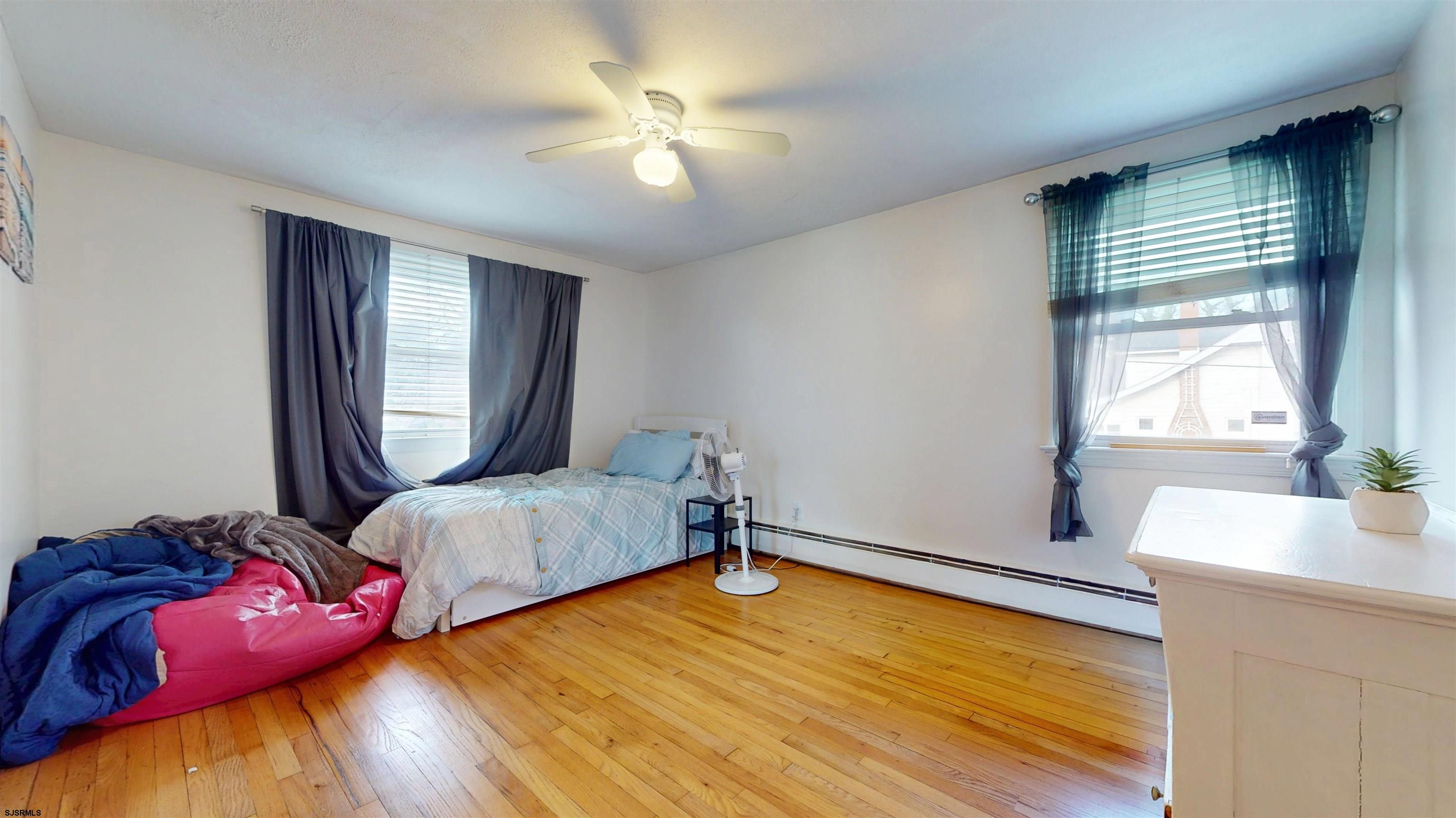 2300 Shore Road Linwood, NJ 08221 - Photo 41 of 50 a bedroom with a bed and a chandelier