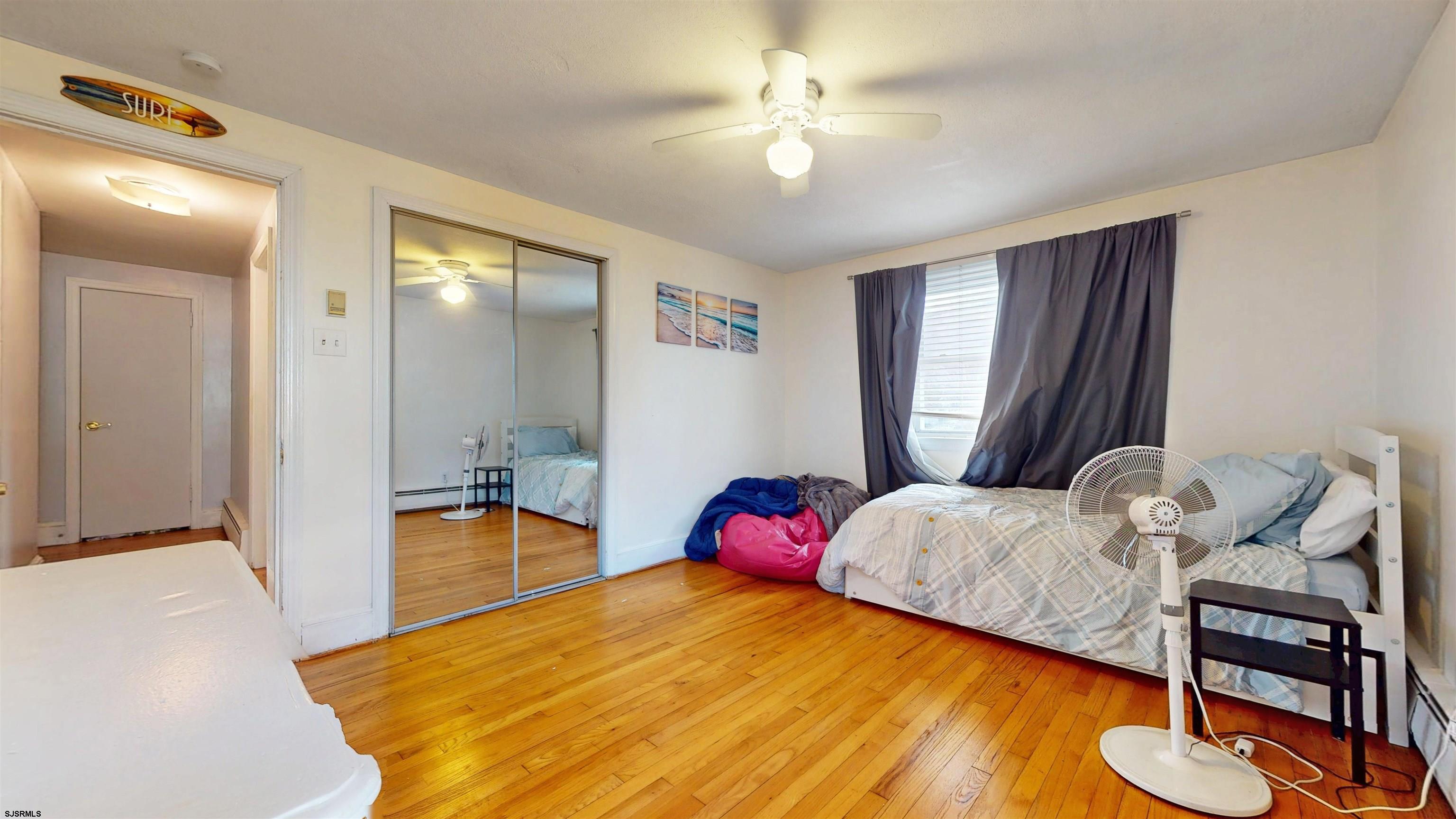 2300 Shore Road Linwood, NJ 08221 - Photo 42 of 50 a bedroom with a bed and a chandelier