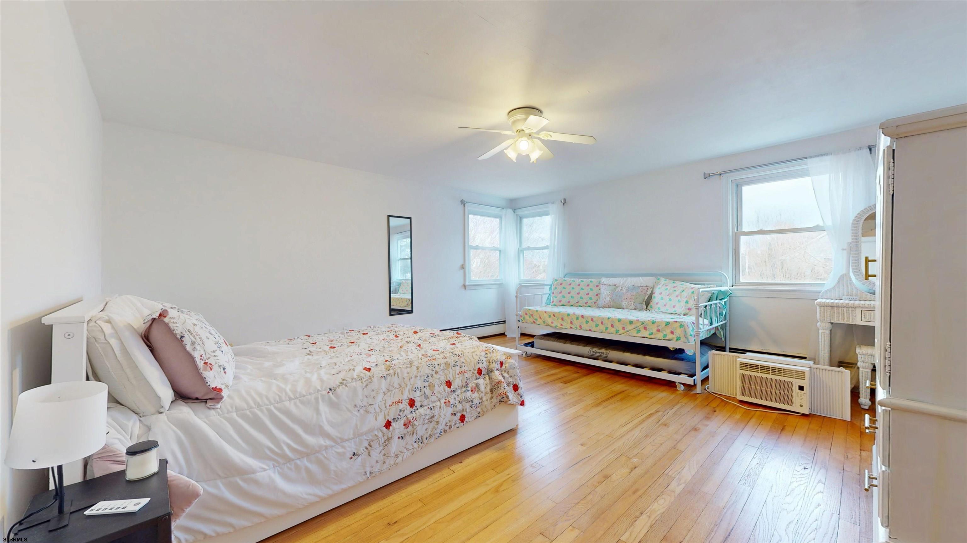 2300 Shore Road Linwood, NJ 08221 - Photo 43 of 50 a bedroom with a bed and a chandelier