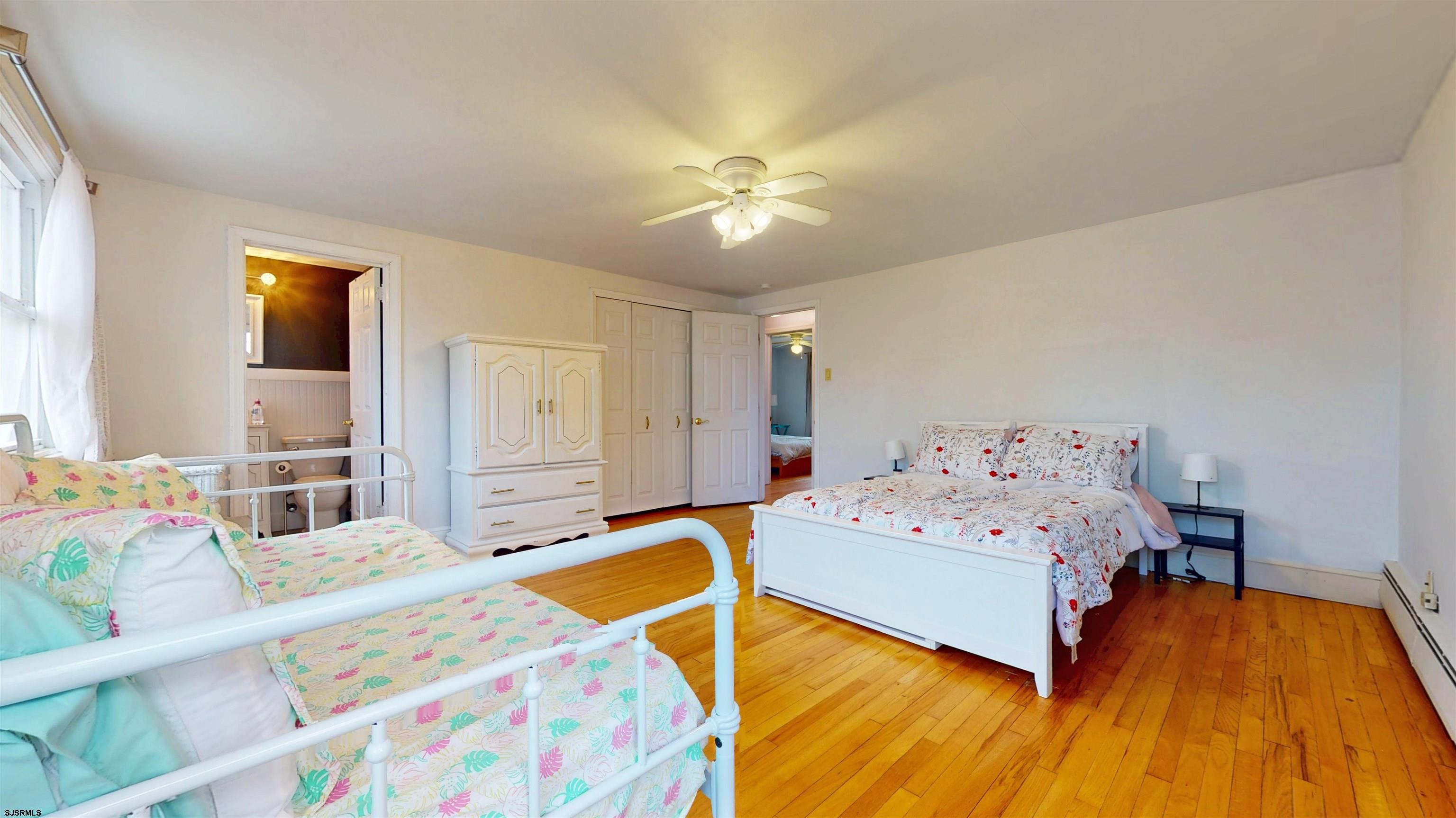 2300 Shore Road Linwood, NJ 08221 - Photo 44 of 50 a bedroom with a bed and wooden floor
