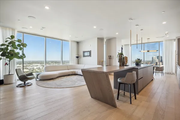 a living room kitchen with furniture and a large window