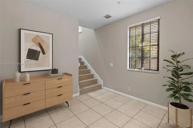 a view of room with stairs and wooden floor