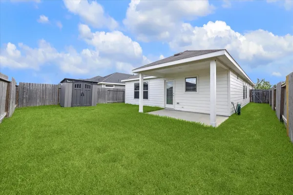 a view of a house with a backyard
